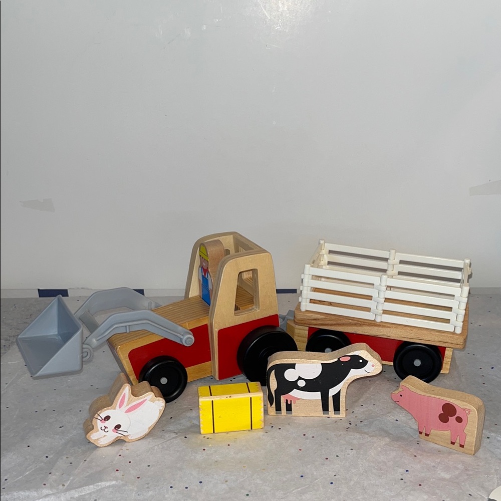 Melissa and Doug… wooden play set, wagon will unhitch from tractor.